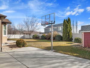 View of sport court featuring a yard