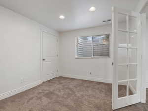 Unfurnished room with light carpet