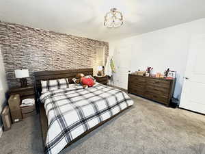 Carpeted bedroom with a textured ceiling