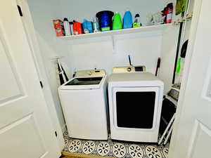 Clothes washing area featuring washing machine and dryer