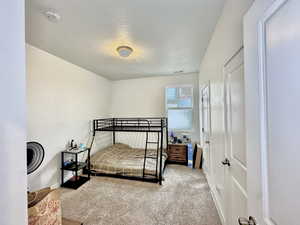Bedroom featuring carpet floors and a textured ceiling