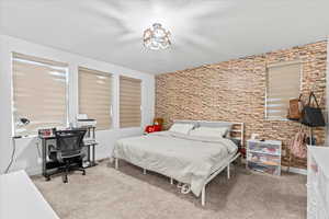 Carpeted bedroom featuring a textured ceiling and baseboards