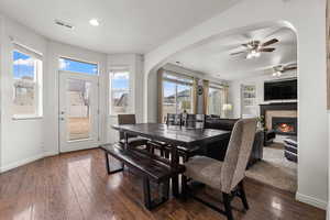 Dining area featuring built in features, ceiling fan, dark hardwood / wood-style floors, and a healthy amount of sunlight