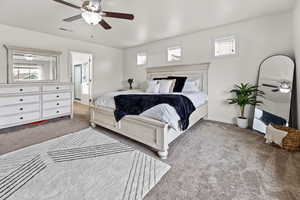 Bedroom with connected bathroom, carpet, and ceiling fan