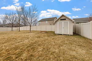 View of yard featuring a storage unit