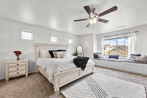 Carpeted bedroom with ceiling fan