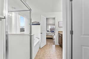 Bathroom featuring vanity, tile patterned flooring, and independent shower and bath