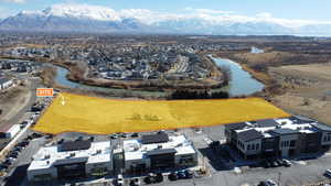 Birds eye view of property with a water and mountain view