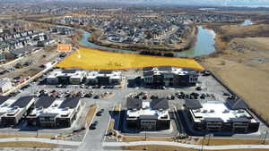 Birds eye view of property with a water view