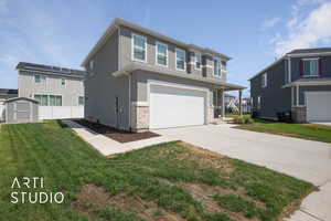 View of front of property with a garage and a front yard