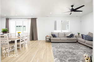 Living room featuring ceiling fan and light wood-type flooring