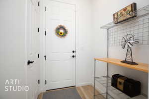 Entryway with light hardwood / wood-style floors