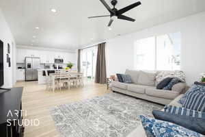 Living room featuring light hardwood / wood-style floors and ceiling fan