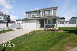 View of front of house featuring a garage, covered porch, and a front yard