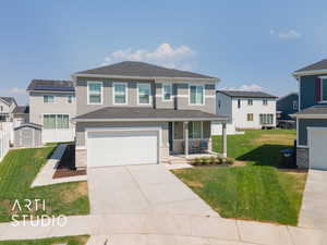 View of front of property featuring a front lawn, a garage, and a porch