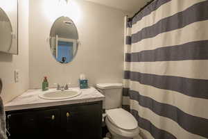 Bathroom featuring vanity, toilet, and walk in shower