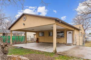 Back of house featuring a carport