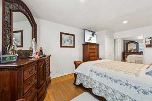 Bedroom with light hardwood / wood-style flooring