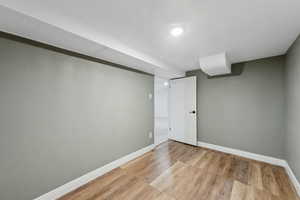 Basement featuring light wood-type flooring