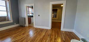 # 9 Unfurnished bedroom featuring hardwood / wood-style flooring, connected bdrm, and cooling unit