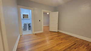 # 9 Unfurnished bedroom featuring light wood-style floors and ensuite bathroom