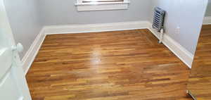 Unit # 3 Detailed view of wood finished floors and baseboards