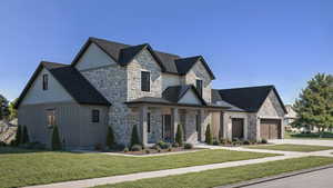 View of front of property with a front lawn and a garage