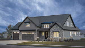 View of front of property with a garage and a front yard