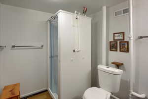 Bathroom featuring a shower and toilet