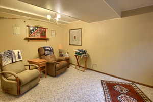 Living area featuring carpet and an inviting chandelier