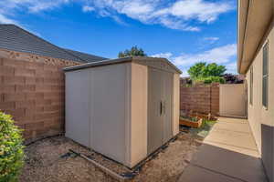 View of shed featuring a fenced backyard