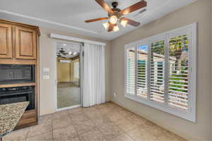 Unfurnished dining area with visible vents, ceiling fan, baseboards, and a healthy amount of sunlight