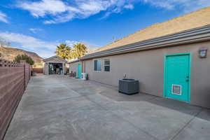 View of patio / terrace featuring a garage, central AC, and a mountain view