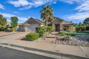 Ranch-style house with concrete driveway, stone siding, a tile roof, an attached garage, and stucco siding