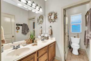 Bathroom with vanity, tile patterned flooring, and toilet