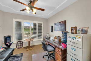 Home office with carpet and ceiling fan