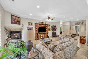 Living room featuring ceiling fan and light tile patterned floors