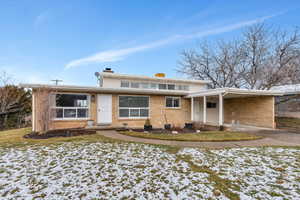 View of front of house with a carport