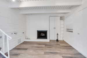 Washroom with hardwood / wood-style flooring, wood ceiling, and wooden walls