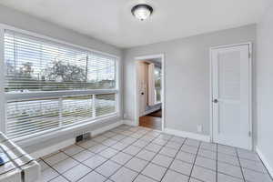 Empty room with light tile patterned floors