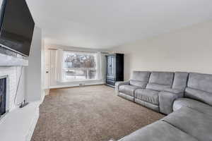 Carpeted living room with a fireplace