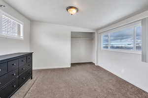 Unfurnished bedroom with a closet and carpet flooring