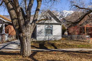 View of side of home with a mountain view