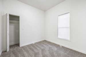 Unfurnished bedroom with carpet floors and a closet