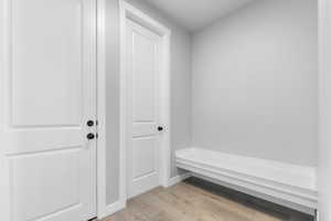 Mudroom featuring light wood-style floors and baseboards