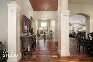 Entryway with dark hardwood / wood-style flooring and ornate columns