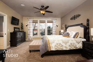 Bedroom featuring ceiling fan, light colored carpet, and a textured ceiling