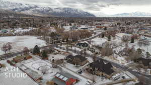 Snowy aerial view featuring a mountain view