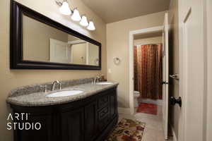 Bathroom with vanity, tile patterned floors, and toilet