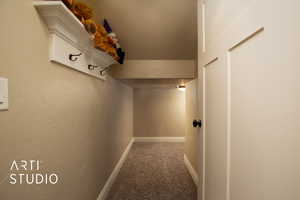 Corridor with carpet floors and a textured ceiling